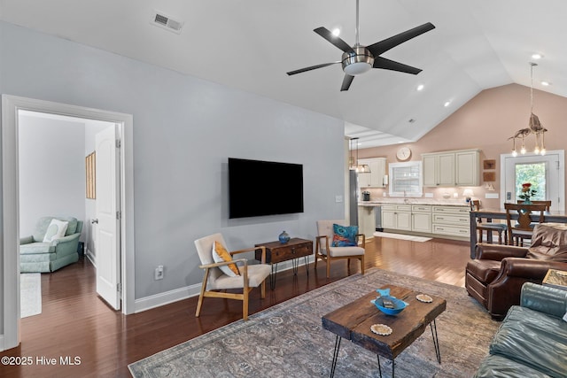 124 NE 35th St, Oak Island, NC 28465 - living area with ceiling fan, wood finished floors, high vaulted ceiling, and baseboards