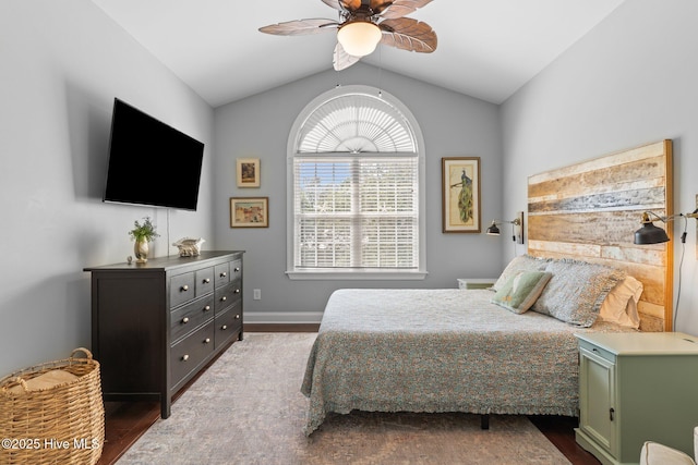 124 NE 35th St, Oak Island, NC 28465 - bedroom with vaulted ceiling, wood finished floors, a ceiling fan, and baseboards