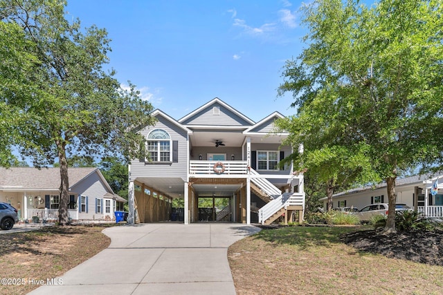 124 NE 35th St, Oak Island, NC 28465 - beach home featuring a carport, a ceiling fan, a porch, stairs, and concrete driveway
