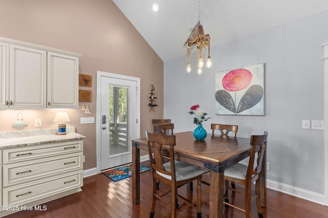 124 NE 35th St, Oak Island, NC 28465 - dining area featuring baseboards, dark wood-style floors, and high vaulted ceiling