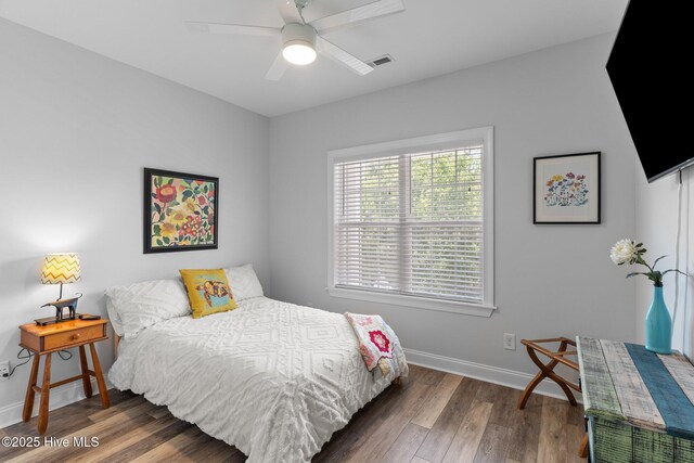 124 NE 35th St, Oak Island, NC 28465 - bedroom with wood finished floors, baseboards, and ceiling fan