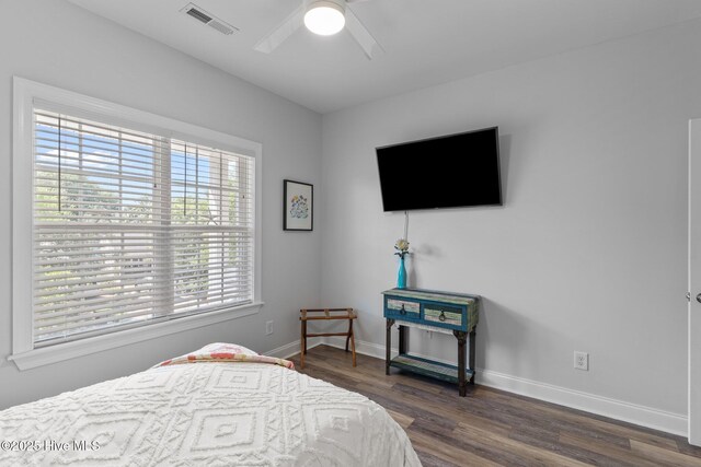 124 NE 35th St, Oak Island, NC 28465 - bedroom with wood finished floors, baseboards, and a ceiling fan