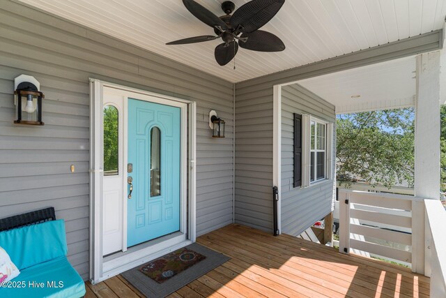 124 NE 35th St, Oak Island, NC 28465 - view of exterior entry featuring ceiling fan and covered porch
