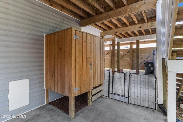 124 NE 35th St, Oak Island, NC 28465 - misc room with unfinished concrete floors and wood walls