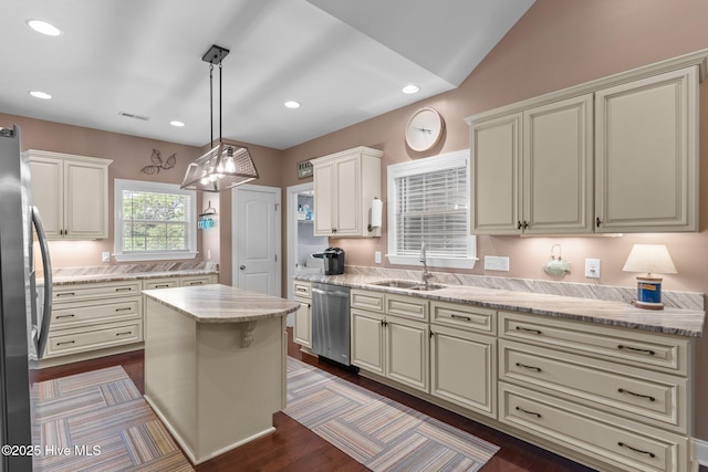 124 NE 35th St, Oak Island, NC 28465 - kitchen with stainless steel appliances, a sink, recessed lighting, light stone countertops, and hanging light fixtures