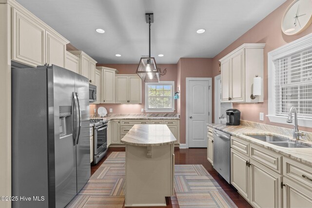 124 NE 35th St, Oak Island, NC 28465 - kitchen with appliances with stainless steel finishes, a sink, light stone countertops, decorative light fixtures, and recessed lighting