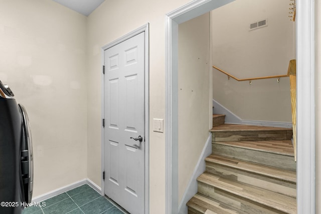 3193 Wexford Way, Southport, NC 28461 - foyer featuring baseboards, stairway, and dark tile patterned flooring