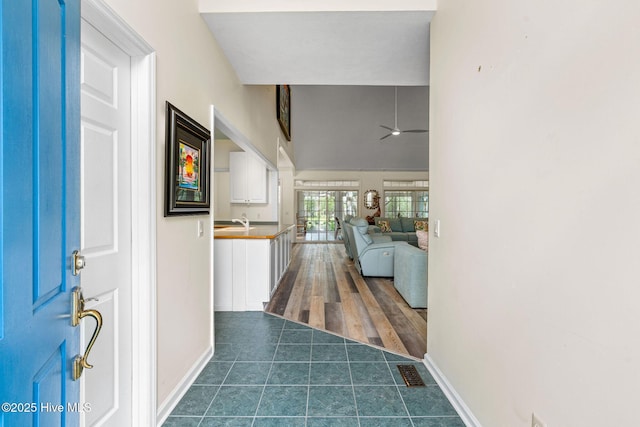 3193 Wexford Way, Southport, NC 28461 - foyer with dark tile patterned flooring, ceiling fan, and baseboards