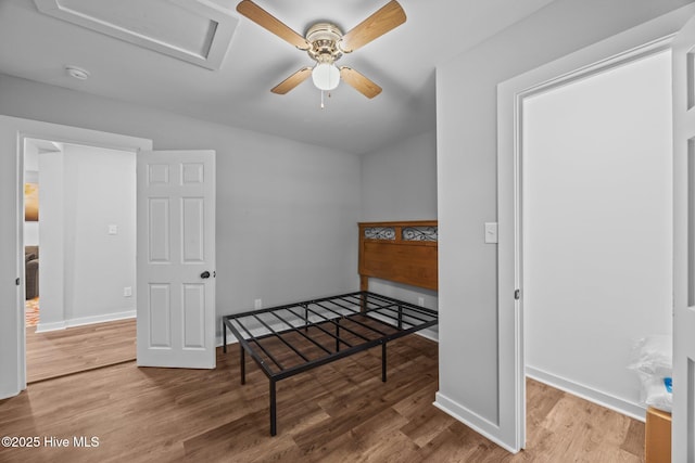 10378 Neuse Rd, Grantsboro, NC 28529 - unfurnished bedroom featuring wood finished floors, attic access, and baseboards