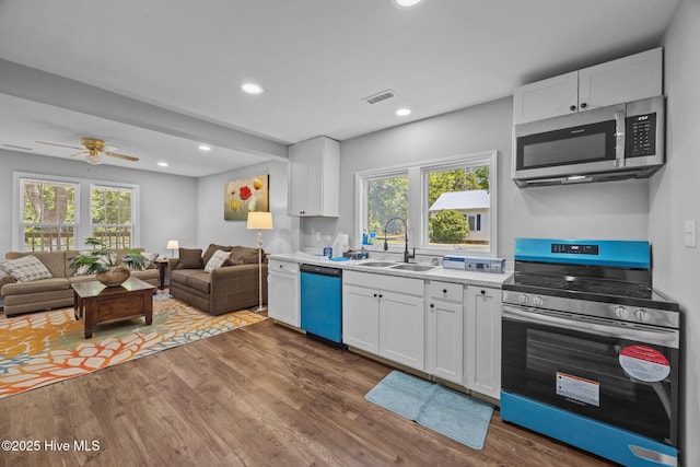 10378 Neuse Rd, Grantsboro, NC 28529 - kitchen with appliances with stainless steel finishes, a sink, wood finished floors, healthy amount of natural light, and recessed lighting