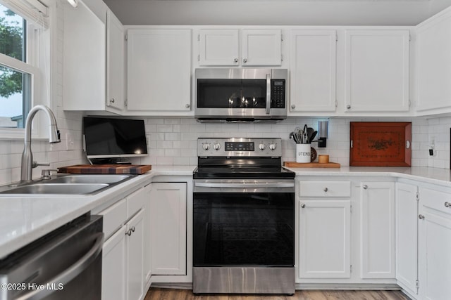 2824 Sapling Cir, Wilmington, NC 28411 - kitchen with appliances with stainless steel finishes, a sink, white cabinetry, and light countertops