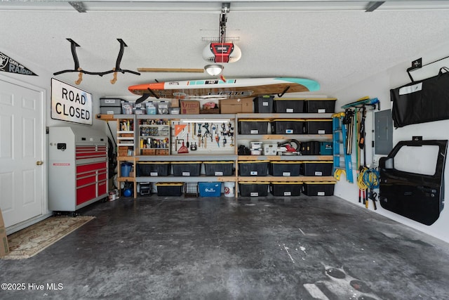 2824 Sapling Cir, Wilmington, NC 28411 - garage featuring a garage door opener, electric panel, and a workshop area