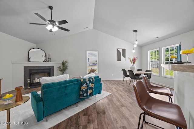 301 Haws Run Rd, Jacksonville, NC 28540 - living room featuring lofted ceiling, a tile fireplace, wood finished floors, a ceiling fan, and baseboards