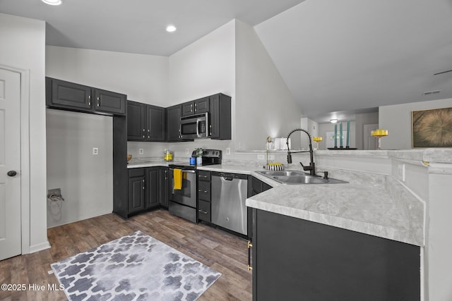 301 Haws Run Rd, Jacksonville, NC 28540 - kitchen featuring appliances with stainless steel finishes, a sink, light countertops, lofted ceiling, and dark wood-style floors