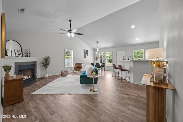301 Haws Run Rd, Jacksonville, NC 28540 - living room with wood finished floors, a tiled fireplace, vaulted ceiling, ceiling fan, and baseboards