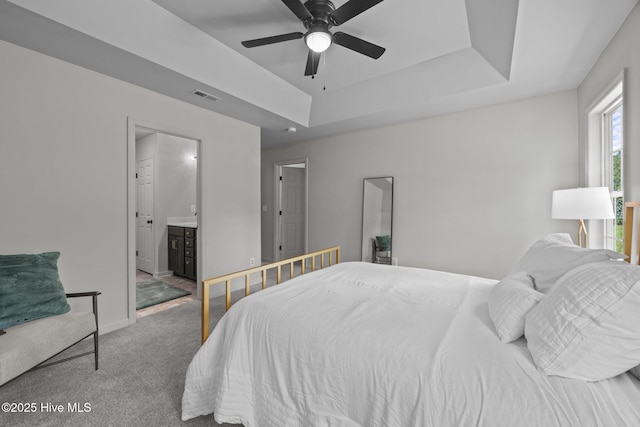 301 Haws Run Rd, Jacksonville, NC 28540 - bedroom featuring carpet, a tray ceiling, baseboards, ensuite bathroom, and ceiling fan