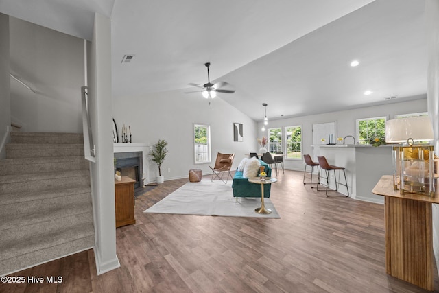301 Haws Run Rd, Jacksonville, NC 28540 - living room with wood finished floors, stairs, a tile fireplace, a ceiling fan, and lofted ceiling