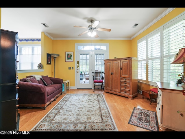 1133 Grandiflora Dr, Leland, NC 28451 - living room featuring a ceiling fan, ornamental molding, light wood-style flooring, baseboards, and french doors