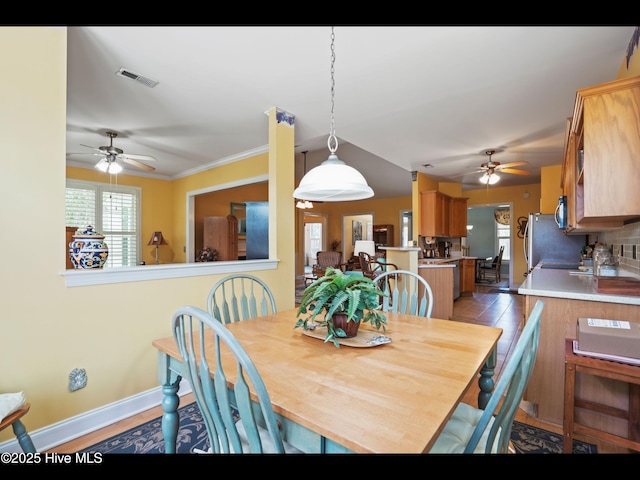 1133 Grandiflora Dr, Leland, NC 28451 - dining area with a ceiling fan, baseboards, and crown molding