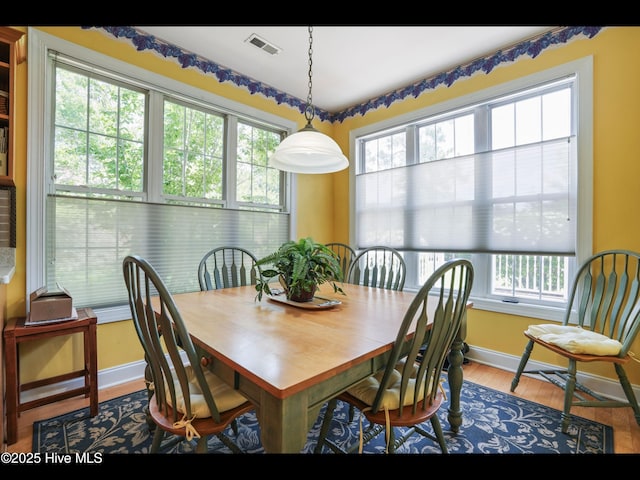 1133 Grandiflora Dr, Leland, NC 28451 - dining area featuring plenty of natural light, baseboards, and wood finished floors