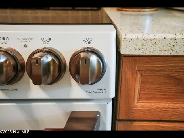 1133 Grandiflora Dr, Leland, NC 28451 - kitchen view of washer / clothes dryer and brown cabinetry
