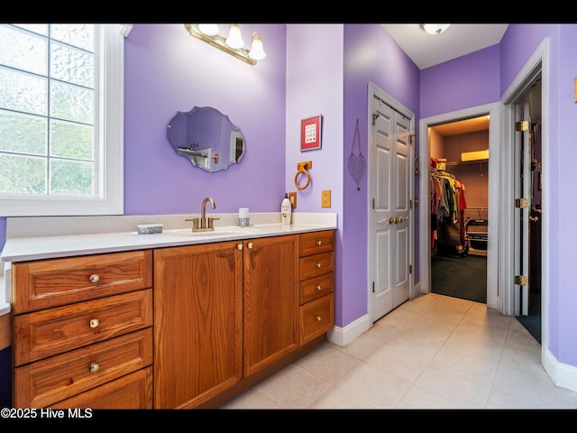 1133 Grandiflora Dr, Leland, NC 28451 - full bathroom with vanity, baseboards, a spacious closet, and tile patterned flooring
