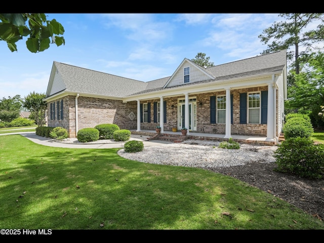 1133 Grandiflora Dr, Leland, NC 28451 - view of front facade with brick siding, a front yard, a porch, and roof with shingles