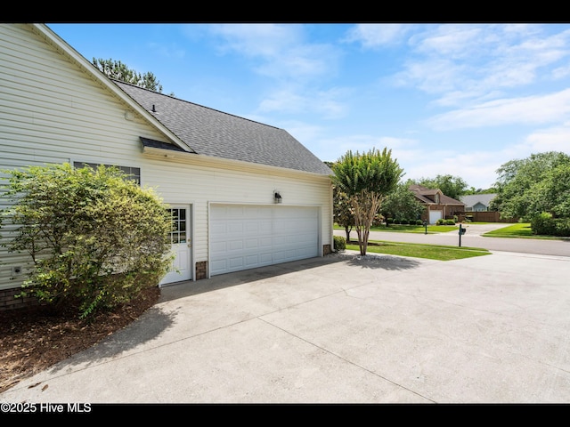 1133 Grandiflora Dr, Leland, NC 28451 - view of side of home with concrete driveway, a shingled roof, and a garage