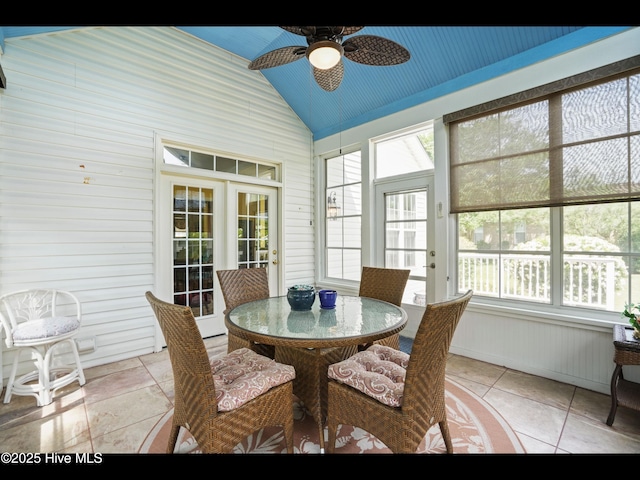 1133 Grandiflora Dr, Leland, NC 28451 - dining space featuring vaulted ceiling, ceiling fan, wooden walls, and light tile patterned floors