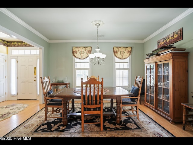 1133 Grandiflora Dr, Leland, NC 28451 - dining room featuring a chandelier, light wood-type flooring, and ornamental molding