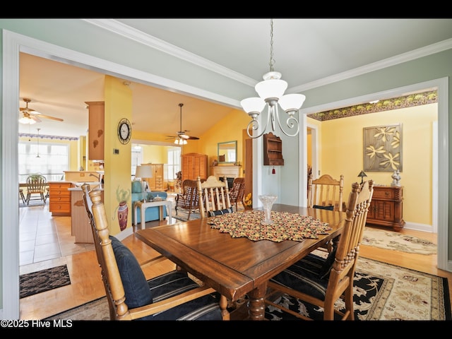 1133 Grandiflora Dr, Leland, NC 28451 - dining room with ceiling fan, crown molding, light wood-style flooring, lofted ceiling, and a chandelier