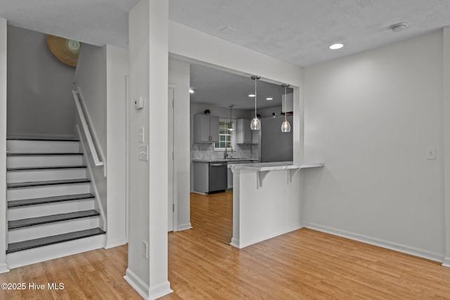 100 Hedingham Ct, Wilmington, NC 28412 - staircase featuring wood finished floors, baseboards, and recessed lighting