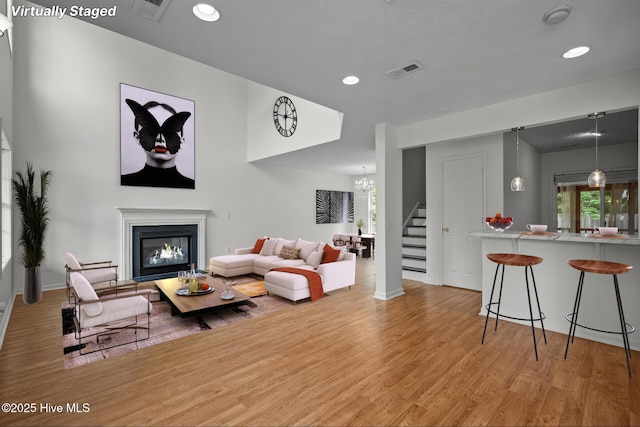 100 Hedingham Ct, Wilmington, NC 28412 - living area with stairway, light wood-style flooring, a glass covered fireplace, baseboards, and recessed lighting