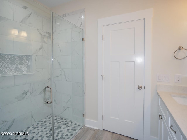 335 NE 41st St, Oak Island, NC 28465 - bathroom featuring a stall shower, vanity, and wood finished floors