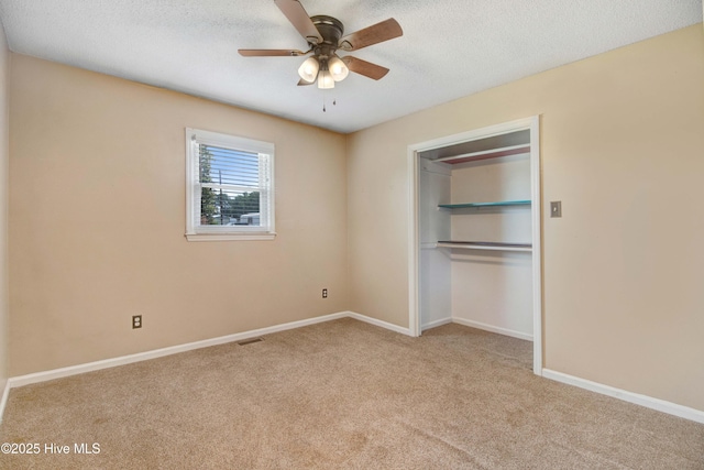 287 Perkins Rd, Goldsboro, NC 27530 - unfurnished bedroom featuring carpet flooring, baseboards, a closet, a textured ceiling, and a ceiling fan