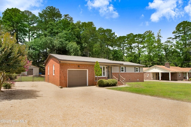 287 Perkins Rd, Goldsboro, NC 27530 - ranch-style home featuring an attached garage, brick siding, and driveway