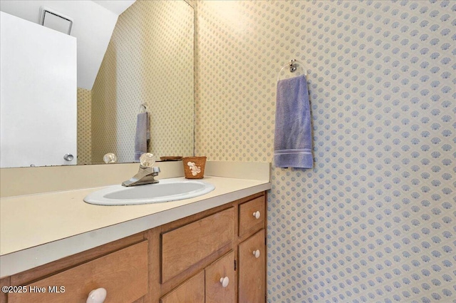 256 Brunswick Ave W Unit A, Holden Beach, NC 28462 - bathroom featuring wallpapered walls and vanity