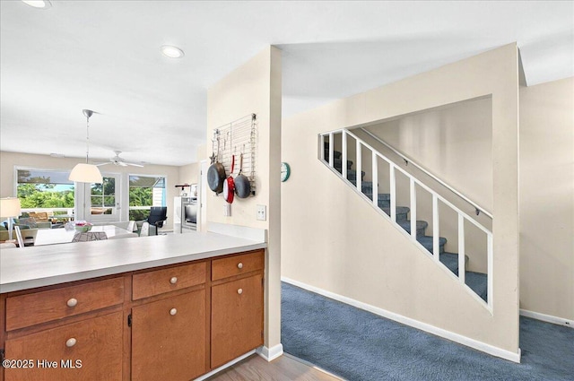 256 Brunswick Ave W Unit A, Holden Beach, NC 28462 - kitchen featuring brown cabinets, light countertops, open floor plan, baseboards, and decorative light fixtures