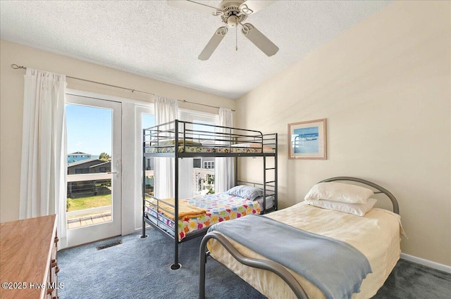 256 Brunswick Ave W Unit A, Holden Beach, NC 28462 - carpeted bedroom featuring access to outside, a textured ceiling, and a ceiling fan