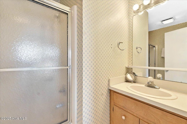 256 Brunswick Ave W Unit A, Holden Beach, NC 28462 - bathroom with wallpapered walls, a shower stall, and vanity