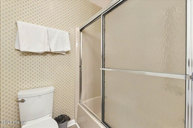 256 Brunswick Ave W Unit A, Holden Beach, NC 28462 - bathroom featuring toilet, wallpapered walls, enclosed tub / shower combo, and baseboards