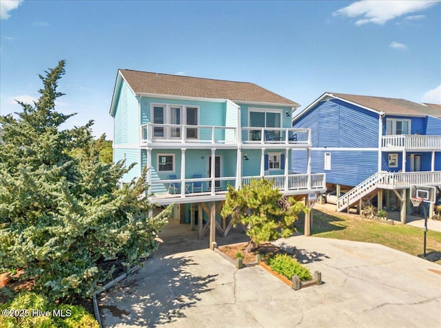 256 Brunswick Ave W Unit A, Holden Beach, NC 28462 - rear view of house with a carport, a balcony, and driveway