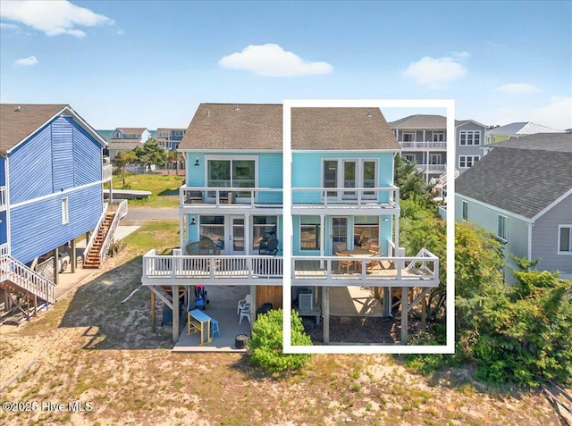 256 Brunswick Ave W Unit A, Holden Beach, NC 28462 - rear view of house with a balcony, stairway, a residential view, and a deck