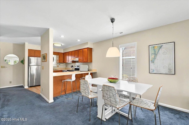 256 Brunswick Ave W Unit A, Holden Beach, NC 28462 - dining area featuring dark carpet and baseboards