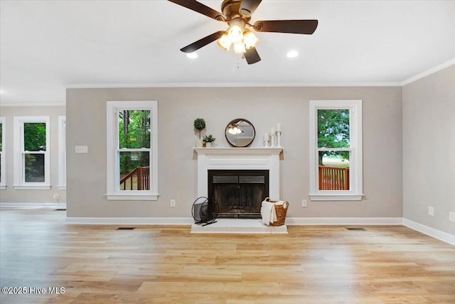 103 Sawgrass Pl, Goldsboro, NC 27534 - unfurnished living room with crown molding, wood finished floors, a fireplace with raised hearth, and ceiling fan