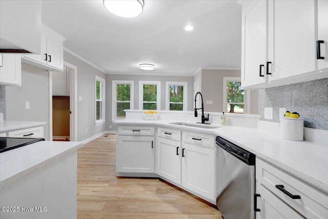 103 Sawgrass Pl, Goldsboro, NC 27534 - kitchen with stainless steel dishwasher, ornamental molding, a peninsula, tasteful backsplash, and light countertops