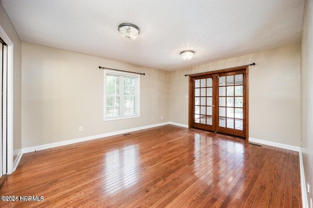 549 Lucas Rd, West End, NC 27376 - unfurnished room featuring french doors, wood-type flooring, and baseboards
