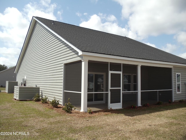 8715 NW Baton Rouge Ave NW Unit 1155-, St Phillips, Calabash, NC 28467 - back of property with central AC unit, roof with shingles, a yard, and a sunroom