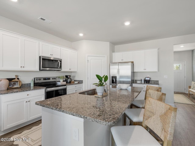159 Legare St Lot 250, Wilmington, NC 28411 - kitchen featuring stainless steel appliances, a sink, an island with sink, light wood finished floors, and white cabinets