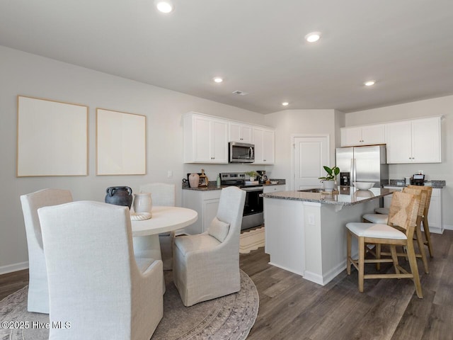 159 Legare St Lot 250, Wilmington, NC 28411 - kitchen featuring stainless steel appliances, dark wood-style flooring, an island with sink, white cabinets, and recessed lighting